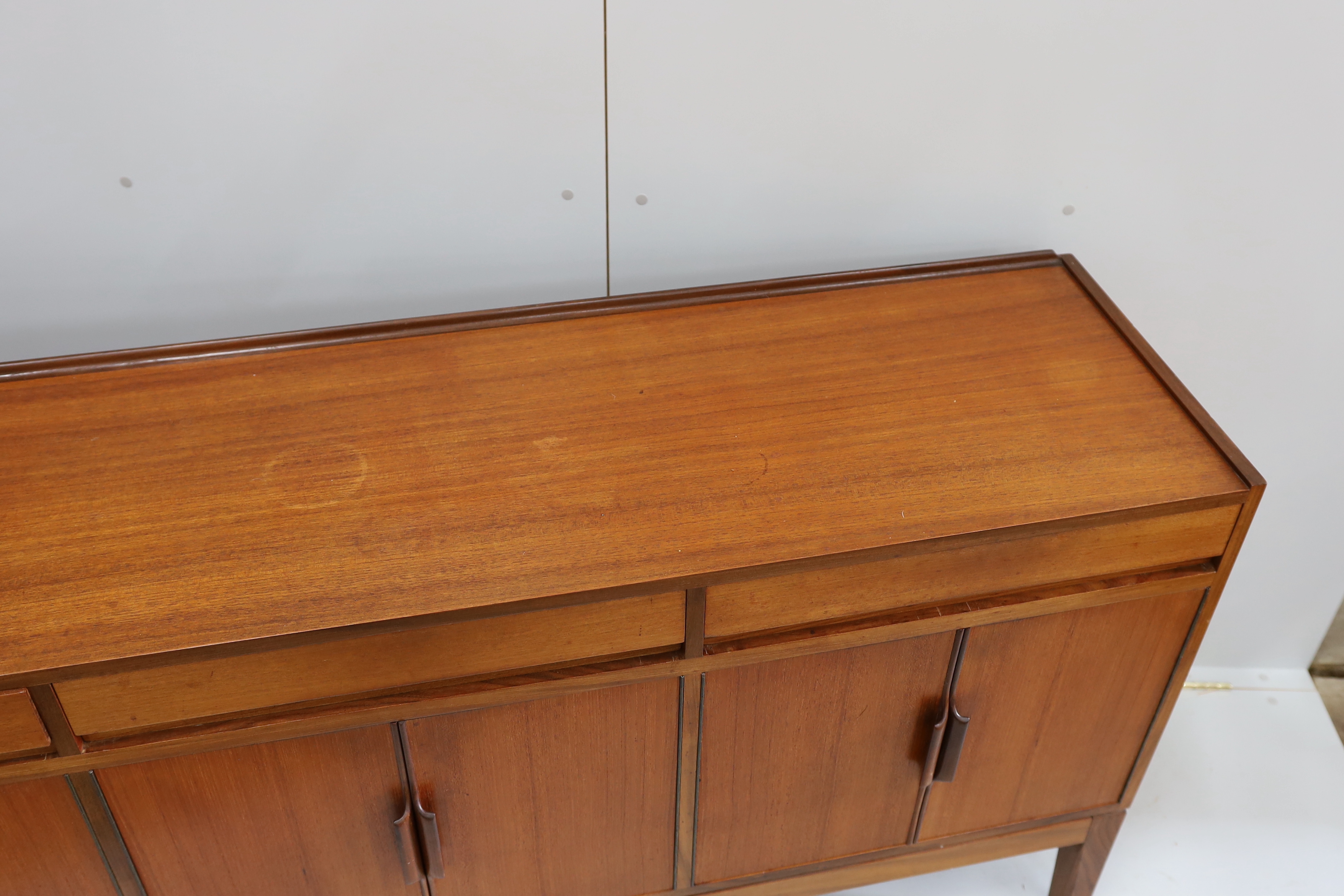 Robert Heritage for Archie Shine, a mid century teak sideboard, length 238cm, depth 46cm, height 86cm